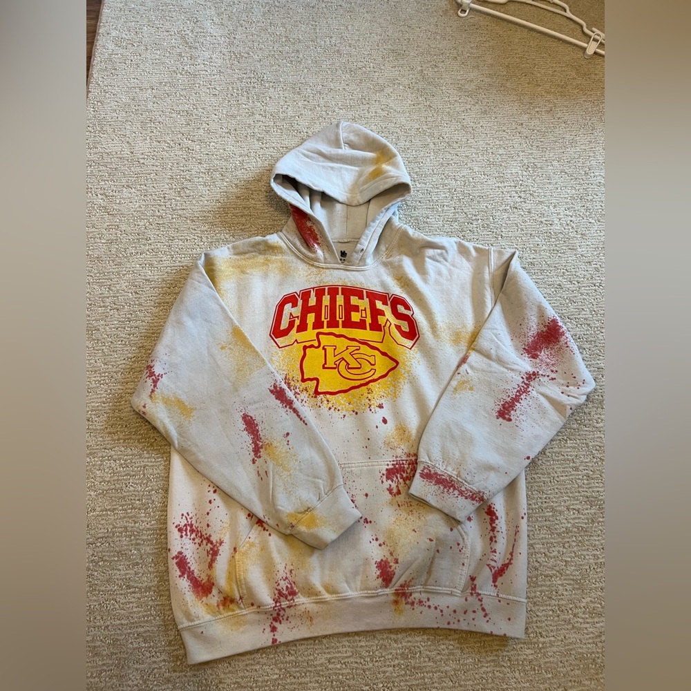 Junk Food Clothing White Chiefs Graphic Hoodie with Red & Yellow Splatter